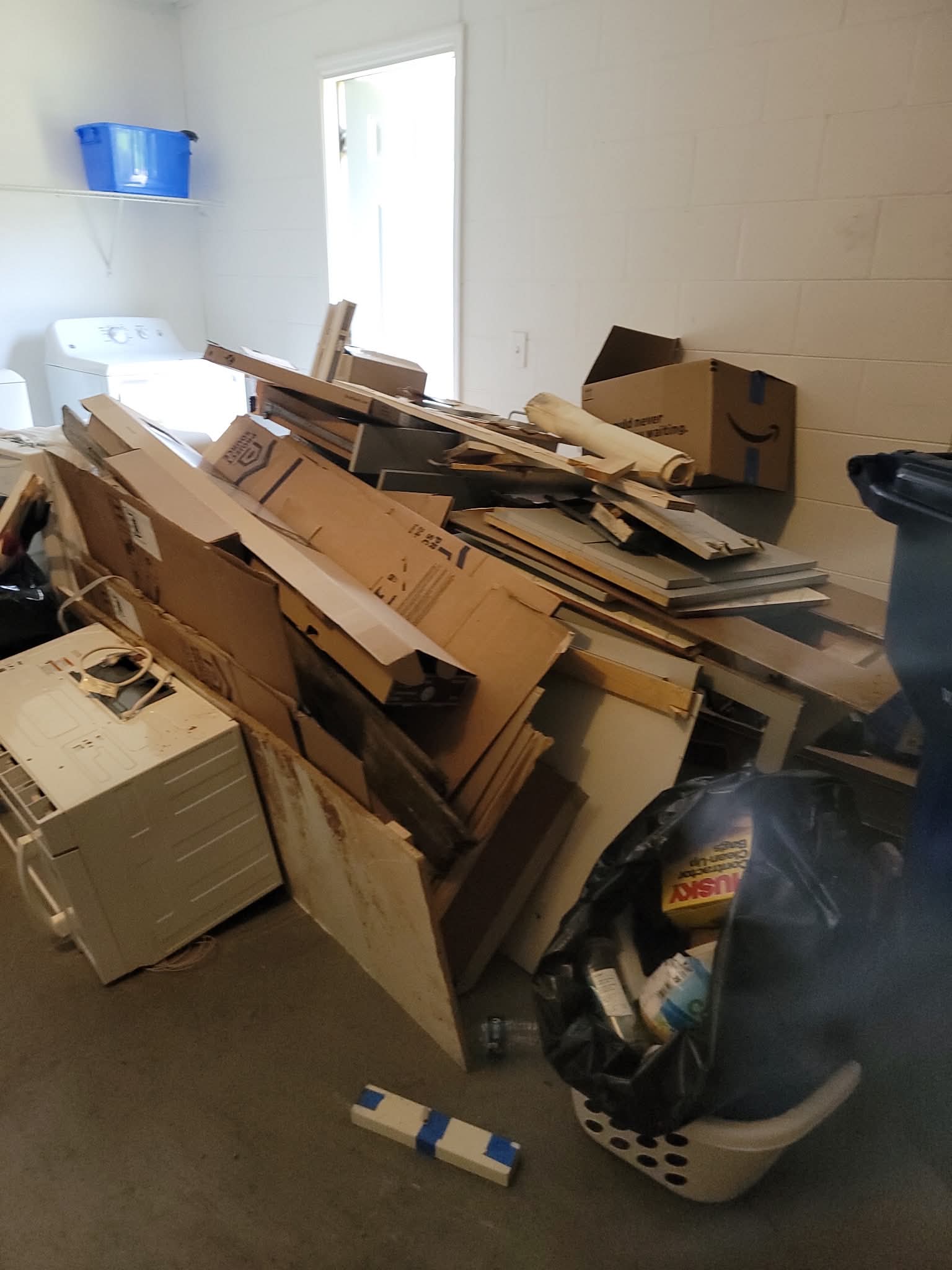 Interior cleanup project with debris and discarded materials